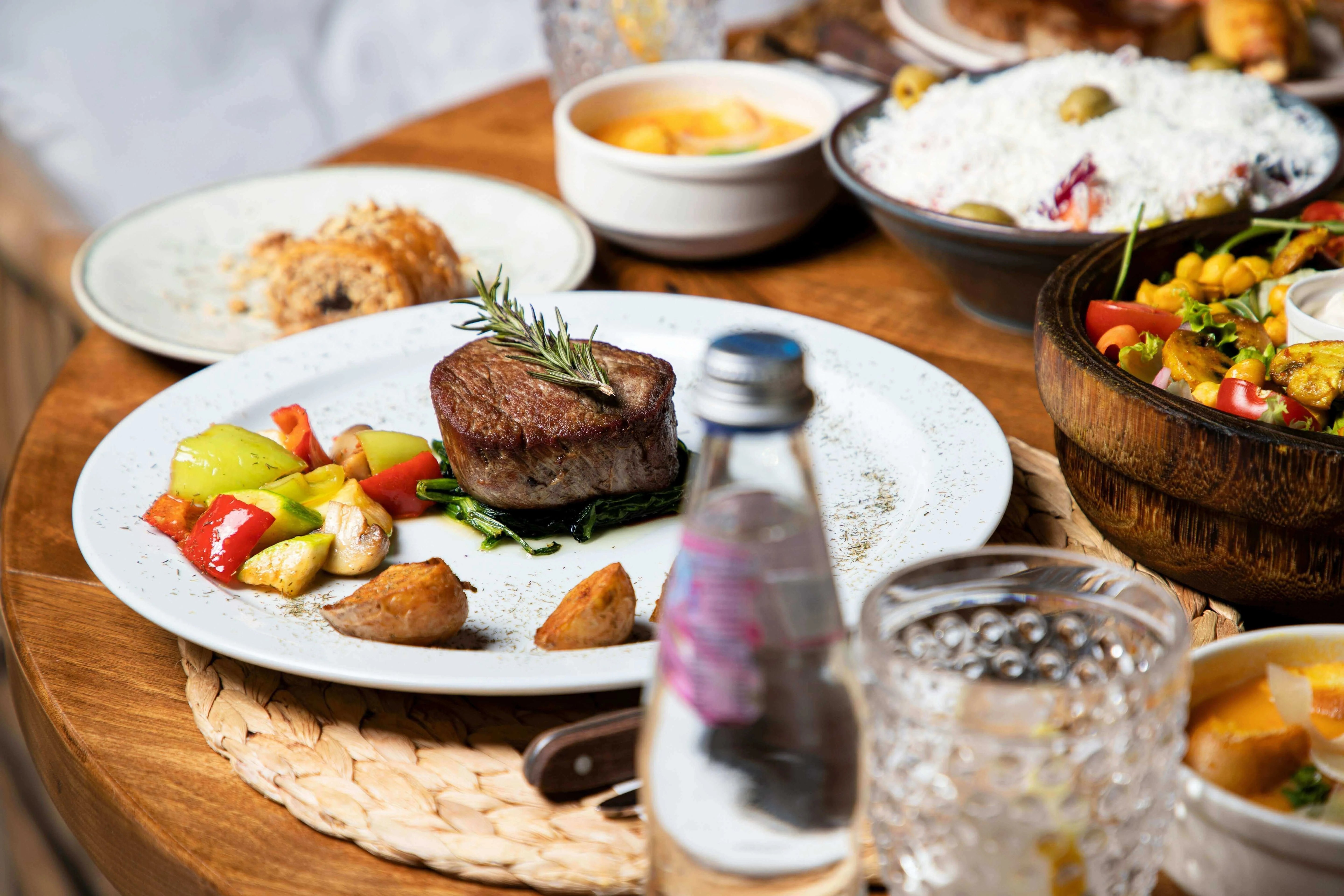 Supporting Liver Health and Bile Function: A Metabolic Approach, featuring a gourmet meal on a wooden table.