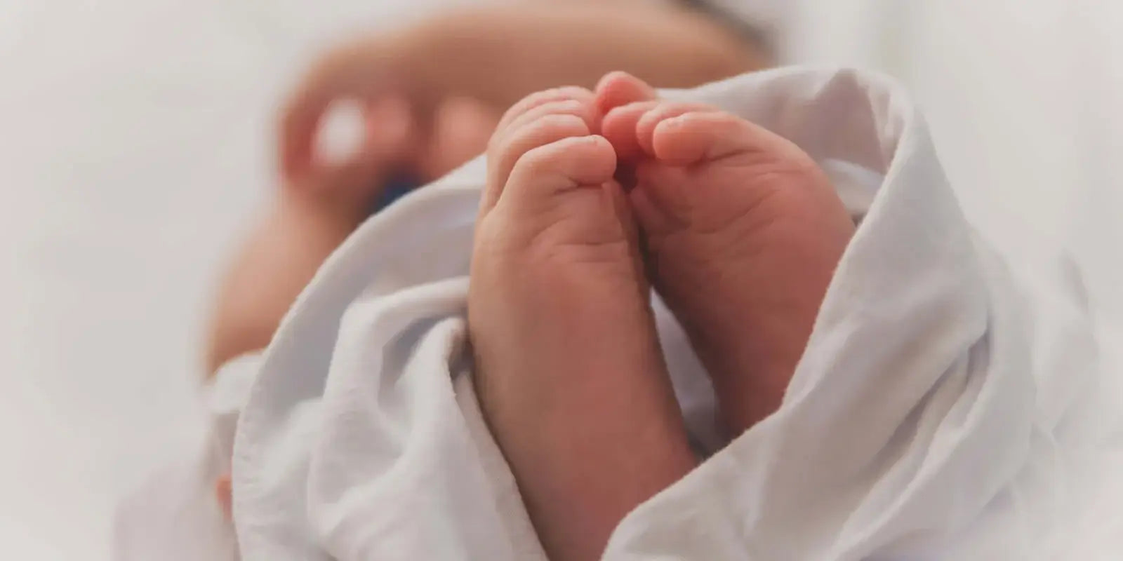 Newborn baby's feet wrapped in a blanket, symbolizing diet and fertility: what the evidence says.