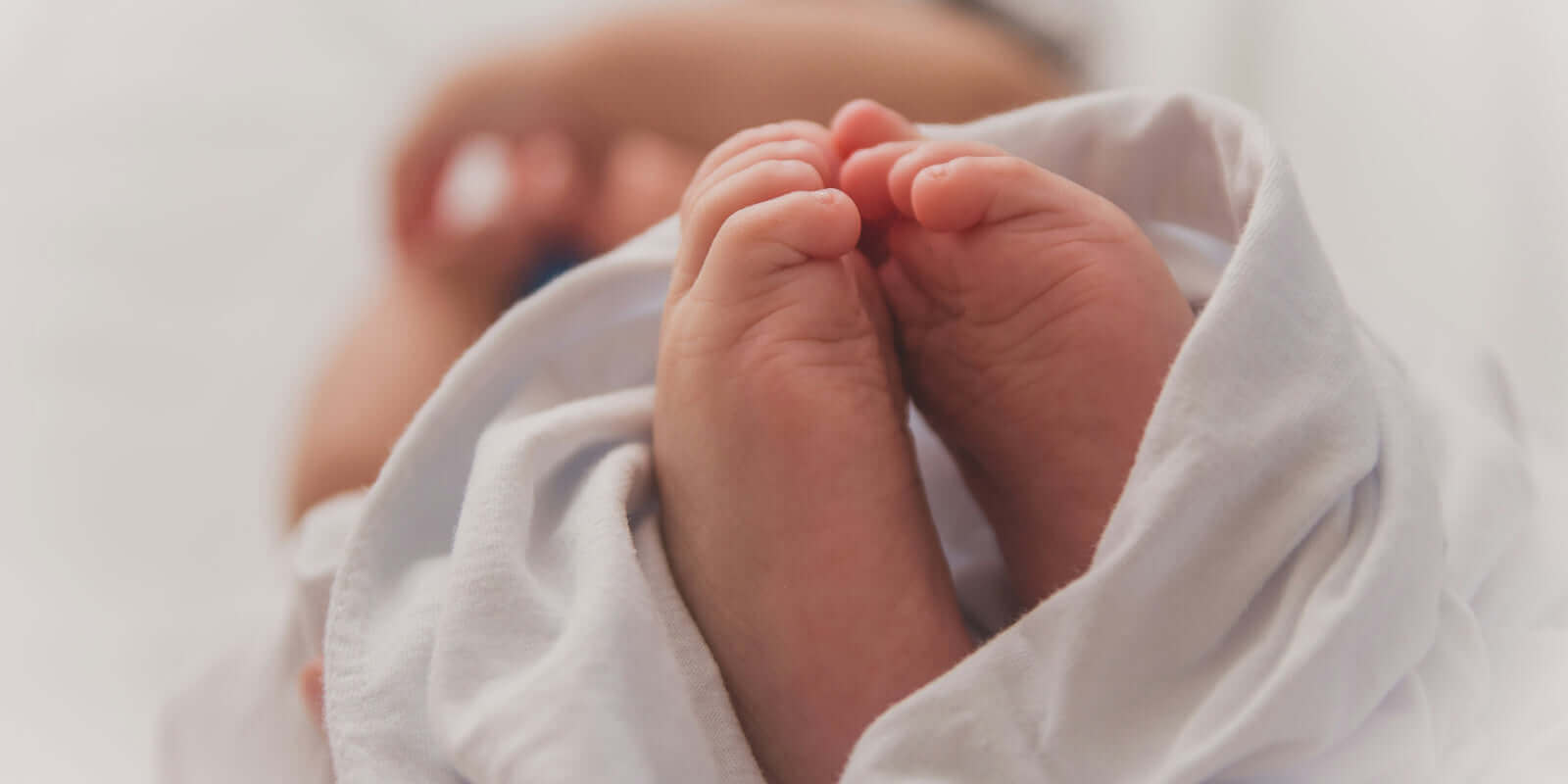 Baby feet wrapped in a towel symbolizing new beginnings and the connection between Diet and Fertility: What the Evidence Says - Windback NZ