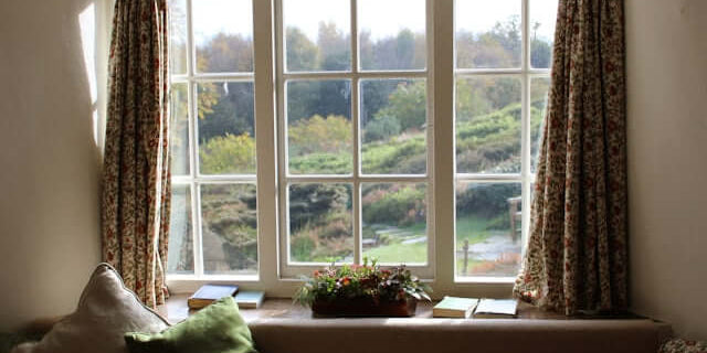 Cozy window view with curtains, showcasing nature outside, perfect for relaxing and caring for your eyes.