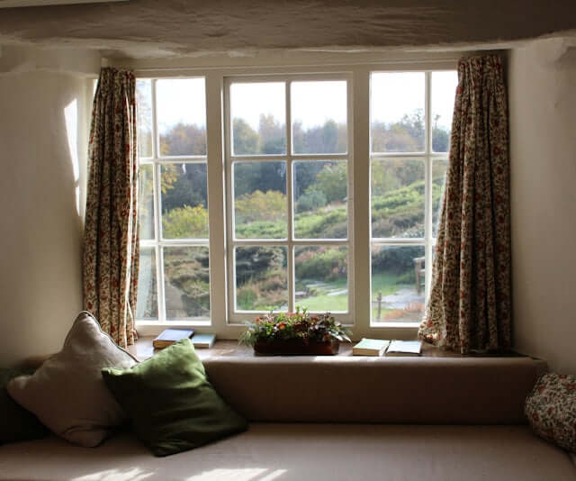 Cozy window view with curtains, showcasing nature outside, perfect for relaxing and caring for your eyes.