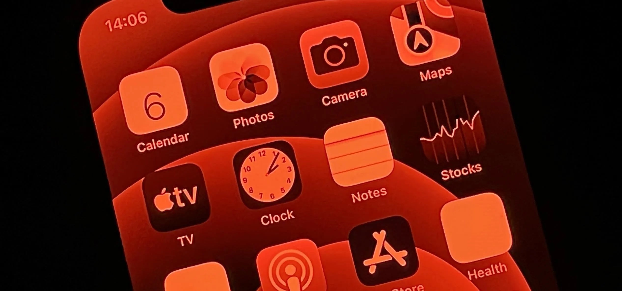 Close-up of a smartphone red screen displaying apps, showcasing how screens can impact sleep.