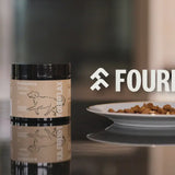 Fourflax pet food packaging on a table with a blurred background