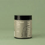 Container of FourFlax Flax Seed Flake on a green background