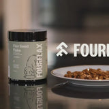 Fourflax flex seed flake container on a table with a blurred background