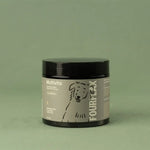 Jar of Fourflax dog multivitamin product on a green background