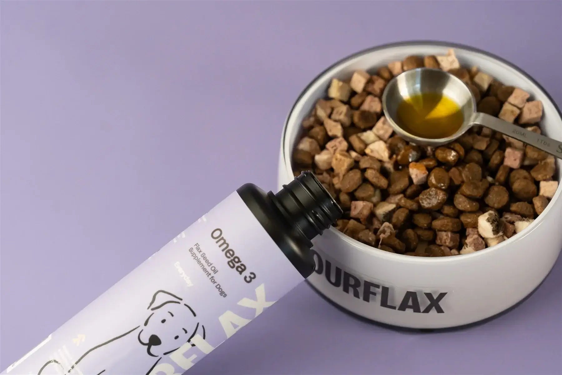 Fourflax Omega 3 supplement bottle next to a bowl of dog food on a purple background