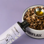 Fourflax Omega 3 supplement bottle next to a bowl of dog food on a purple background