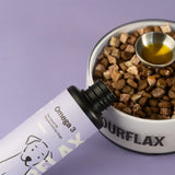 Fourflax Omega 3 supplement bottle next to a bowl of dog food on a purple background