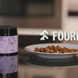 Fourflax pet food container and plate with food on a kitchen counter
