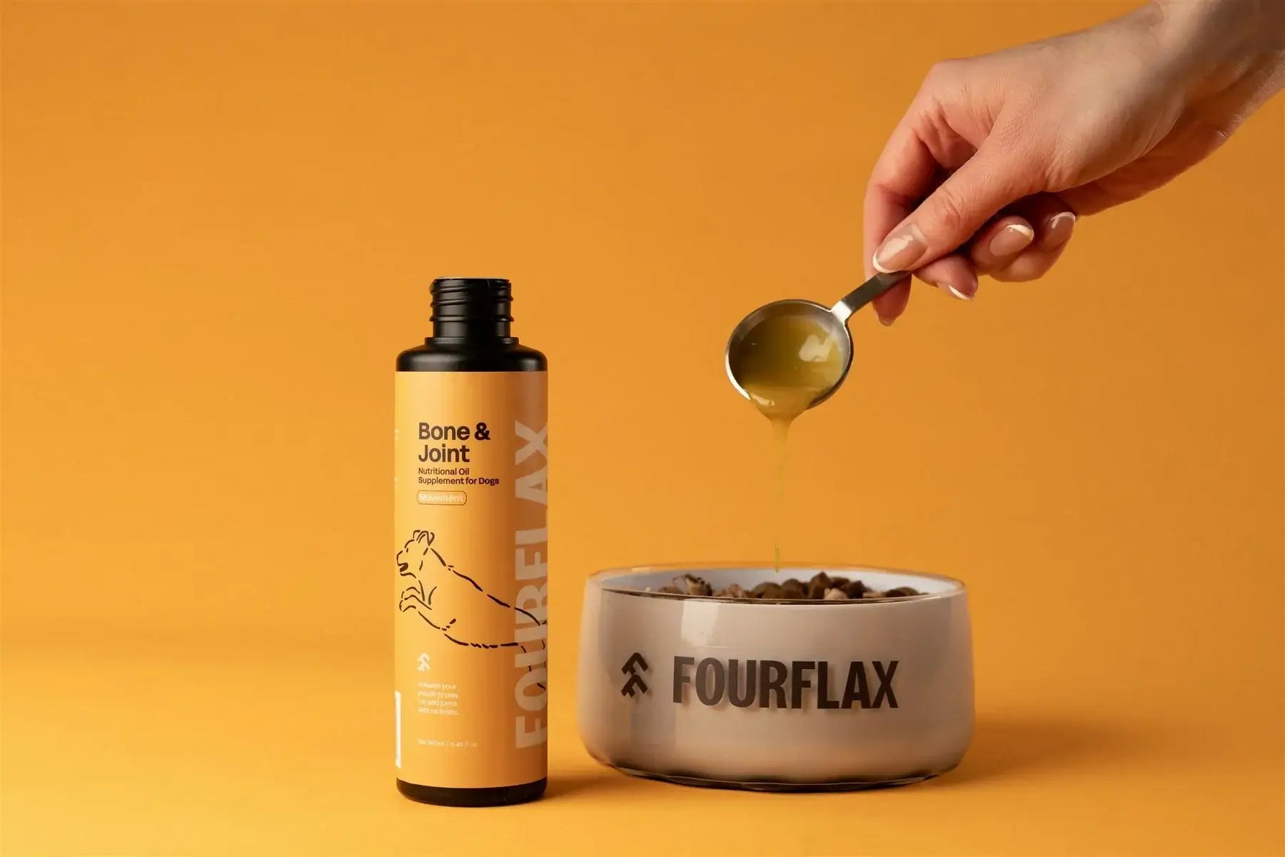 Bottle of Fourflax supplement and a bowl with a hand pouring liquid into it on an orange background