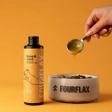 Bottle of Fourflax supplement and a bowl with a hand pouring liquid into it on an orange background