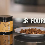 Fourflax almond powder container and a plate of almond-flavored dog food on a reflective surface.