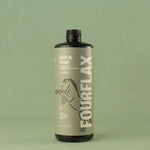 Bottle of FourFlax Skin & Coat supplement on a green background